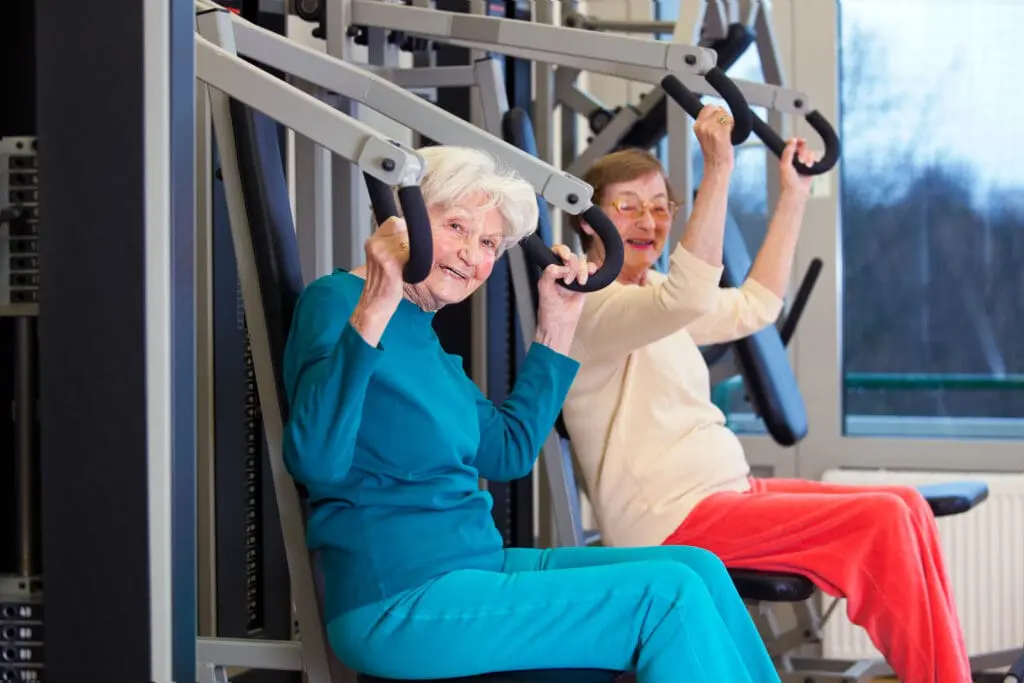 The Best Group Exercise Classes for Seniors That Empower Senior Wellness 1 Senior women working out using arm press
