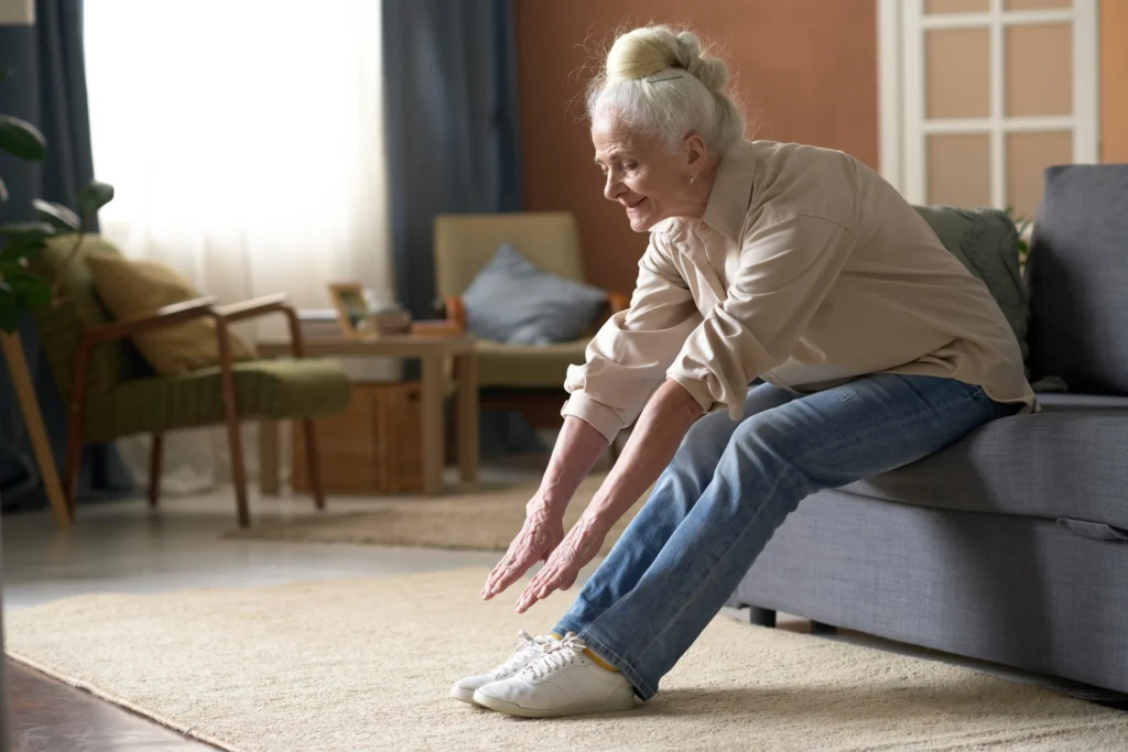 senior woman stretches to touch her toes