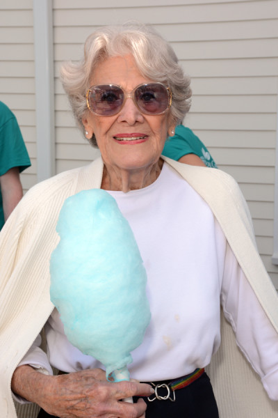 Cotton candy in hand, Village at Proprietors Green resident Carolyn Mancini is ready to embrace the annual Family Fun Day at the senior living community.