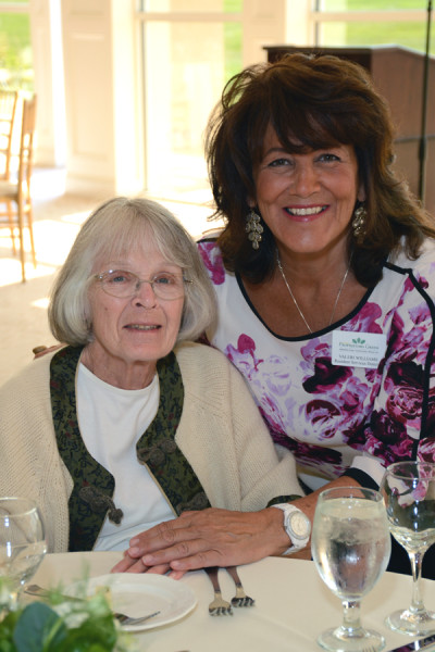Village at Proprietors Green assisted living resident Nancy Powers enjoys the recent annual Assisted Living Week Luncheon. Here she is greeted by the community’s Resident Services Manager, Valeri Williams.