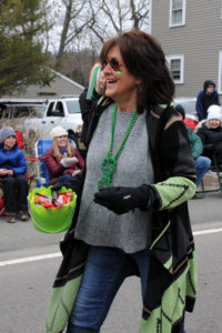 Scituate resident and Resident Services Director for Village at Proprietors Green Valeri Williams briskly walks the parade route, sharing smiles and candy with onlookers.