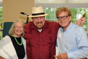Guests of Village at Proprietors Green Murder Mystery Theatre Event Eileen (left) and Brian (right) Donnelly, pose with Hat Trick Theatre player, Jay Savage.
