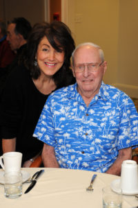 Resident Services Director Valeri Williams greets resident Jack Richardson for the monthly event.