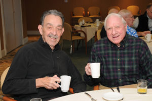 Residents Don Giumetti (left) and Stan Roller (right) find the breakfast gathering a perfect time to relax and catch-up.