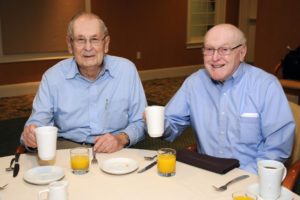 Enjoying juice and coffee and awaiting the main event at the Men's Breakfast are (left to right) Village at Proprietors Green residents Bob Roth and Ellsworth Brown.