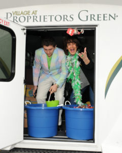 Resident Services Director for Village at proprietors Green Valeri Williams and her son Jack toss candy to the crowd during the Scituate St. Patrick’s Day Parade.