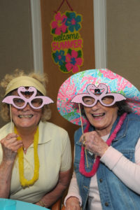 Residents Priscilla Burgess and Chris O’Brien get into the swing of things with their pink flamingo eye disguise.