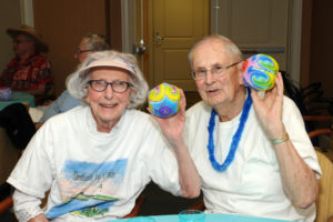 Friends Edith Griffiths and Bob Roth are perched to throw their mini beach balls during the Dance Party extravaganza.