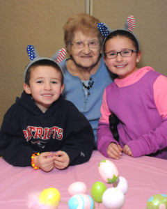 Resident Rose Micknowicz shares a smile with Fynn Crowell (left) and his sister, Maddy Crowell.