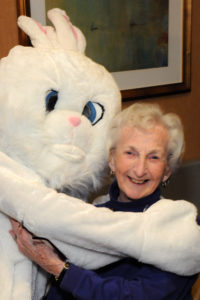 The Easter Bunny shares a hug with resident Anne Laskey.
